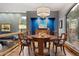 Stylish dining room featuring hardwood floors, a large window with wooded views and a modern chandelier at 3816 Spring Valley Trl, Evergreen, CO 80439