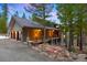 Beautiful exterior featuring a well-maintained two-car garage and stone-accented porch columns at 3816 Spring Valley Trl, Evergreen, CO 80439