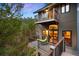 Multi-level deck offering forest views and access to interior living spaces at 3816 Spring Valley Trl, Evergreen, CO 80439