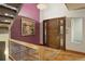Bright foyer with hardwood floors, a statement wall color, and a wooden front door at 3816 Spring Valley Trl, Evergreen, CO 80439
