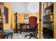Bright home office featuring natural light, a desk, a bookshelf and orange walls at 3816 Spring Valley Trl, Evergreen, CO 80439