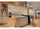 Gourmet kitchen featuring custom cabinets, stainless steel appliances, and a breakfast bar at 3816 Spring Valley Trl, Evergreen, CO 80439
