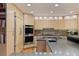 Stylish kitchen with updated appliances, custom cabinets, and sleek countertops at 3816 Spring Valley Trl, Evergreen, CO 80439