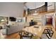 Open concept living and dining area with views of the kitchen and surrounding landscape at 3816 Spring Valley Trl, Evergreen, CO 80439