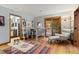 Bright living room featuring a modern desk, office space, stylish chair and doorway to bathroom at 3816 Spring Valley Trl, Evergreen, CO 80439
