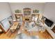Open-concept living area with a stone fireplace, dining table, and views through large windows at 3816 Spring Valley Trl, Evergreen, CO 80439