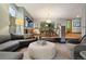 Cozy living room featuring an ottoman, comfortable seating, and an adjacent dining area at 3816 Spring Valley Trl, Evergreen, CO 80439