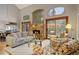 Bright living room featuring a stone fireplace, hardwood floors, and comfortable seating at 3816 Spring Valley Trl, Evergreen, CO 80439