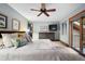 Serene main bedroom with a ceiling fan, sitting area, and access to a private balcony at 3816 Spring Valley Trl, Evergreen, CO 80439