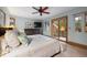 Serene main bedroom with a ceiling fan, sitting area, and access to a private balcony at 3816 Spring Valley Trl, Evergreen, CO 80439