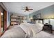 Serene main bedroom with a ceiling fan, access to a deck, and bookshelves at 3816 Spring Valley Trl, Evergreen, CO 80439