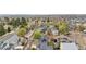 An aerial view shows a neighborhood full of mature trees, green spaces, and many well-maintained homes at 2119 W 101St Cir, Thornton, CO 80260