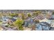 This is an aerial view of a neighborhood full of mature trees with a home that has solar panels on the roof at 2119 W 101St Cir, Thornton, CO 80260