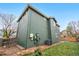 Exterior shot of a two-story home with dark green siding and a grass backyard with a fence at 2119 W 101St Cir, Thornton, CO 80260