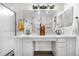Bright bathroom featuring a double vanity with marble countertops and a glass-enclosed shower at 2119 W 101St Cir, Thornton, CO 80260