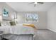 A peaceful bedroom with natural light showcases a relaxing space, plush carpeting, and modern style at 2119 W 101St Cir, Thornton, CO 80260