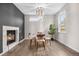 Sunlit dining room with a decorative fireplace, modern light fixture, and sleek table setting at 2119 W 101St Cir, Thornton, CO 80260