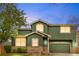 Charming two-story home featuring a stone facade, green exterior, and a two-car garage at 2119 W 101St Cir, Thornton, CO 80260
