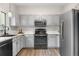 Modern kitchen featuring stainless steel appliances, gray cabinets, and sleek countertops at 2119 W 101St Cir, Thornton, CO 80260