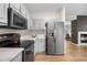 A modern kitchen with stainless steel appliances, white cabinets, and marble countertops gleams with natural light at 2119 W 101St Cir, Thornton, CO 80260