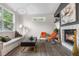 Bright living room featuring a fireplace, modern decor, and ample natural light at 2119 W 101St Cir, Thornton, CO 80260