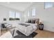Bright bedroom with multiple windows, stylish decor, and a comfortable chair at 964 Quitman St, Denver, CO 80204