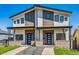 Modern duplex with stylish black windows, neutral paint scheme, and inviting entrances with brick accents at 964 Quitman St, Denver, CO 80204
