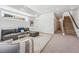 Open living space with comfortable sectional, stairs, and modern accents at 964 Quitman St, Denver, CO 80204
