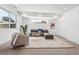 Bright living room with large windows, cozy seating, and stylish rug at 964 Quitman St, Denver, CO 80204