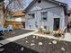 Charming backyard featuring patio seating and a mulched garden with mature trees at 2725 N Gaylord St, Denver, CO 80205