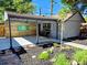 Outdoor patio featuring a built-in bar, wood wall, and lush landscaping at 2725 N Gaylord St, Denver, CO 80205