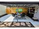 Covered outdoor patio with stylish furniture, a built-in bar, and decorative artwork at 2725 N Gaylord St, Denver, CO 80205