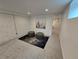 A cozy basement seating area with modern decor, including ottomans, a neutral rug, and stylish wall art at 2725 N Gaylord St, Denver, CO 80205