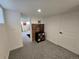 Finished basement with exposed brick, neutral carpet, and doorway at 2725 N Gaylord St, Denver, CO 80205