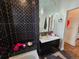 Modern bathroom features a sleek black vanity, decorative mirrors, and a stylish shower with intricate tile work at 2725 N Gaylord St, Denver, CO 80205