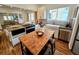 Open kitchen with stainless steel appliances and an island with counter seating at 2725 N Gaylord St, Denver, CO 80205