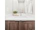 Stylish powder room featuring a modern vanity with white countertop and wood cabinetry at 2828 N Federal Blvd, Denver, CO 80211