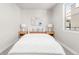 Neutral bedroom features a plush bed, matching nightstands, and a bright window view at 2828 N Federal Blvd, Denver, CO 80211