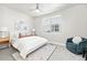 Bright bedroom with a large window, a ceiling fan and a comfortable bed and furniture at 2828 N Federal Blvd, Denver, CO 80211