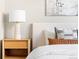 Close-up of a well-appointed bedroom with a bedside table, lamp, and decorative pillows at 2828 N Federal Blvd, Denver, CO 80211