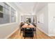 Open dining area with a large wood table and chairs, illuminated by natural light from nearby windows at 2828 N Federal Blvd, Denver, CO 80211