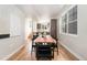 Dining area featuring a wood table with black chairs adjacent to a modern kitchen and staircase at 2828 N Federal Blvd, Denver, CO 80211