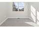 Bright, carpeted room with a large window offering views, ready for personalization at 2828 N Federal Blvd, Denver, CO 80211
