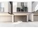 Modern townhouse exterior featuring grey doors, a balcony, and sleek architectural design at 2828 N Federal Blvd, Denver, CO 80211