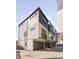 Contemporary townhome exterior with modern design, balcony, and attached garage at 2828 N Federal Blvd, Denver, CO 80211