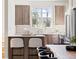 Modern kitchen with wooden cabinets, stainless steel appliances, and a breakfast bar with seating at 2828 N Federal Blvd, Denver, CO 80211