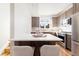 Bright kitchen featuring stainless steel appliances, wood cabinets, and a breakfast bar with modern seating at 2828 N Federal Blvd, Denver, CO 80211