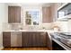 Well-lit kitchen with stainless steel appliances, wood cabinets, and a white tile backsplash at 2828 N Federal Blvd, Denver, CO 80211