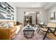 Comfortable living room features a leather couch, area rug, and decorative art with a balcony in the background at 2828 N Federal Blvd, Denver, CO 80211