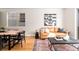 Cozy living area with a leather sofa, modern art, and a wood dining table nearby at 2828 N Federal Blvd, Denver, CO 80211